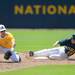 Chelsea senior Ryan Koenn beats St. Joseph second-baseman sophomore Matthew Peirce to the base during their quarter final match up at Ray Fisher Stadium on Tuesday. Melanie Maxwell I AnnArbor.com